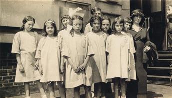 HINE, LEWIS W. (1874-1940) Family group at Ellis Island (with immigrants behind a hurricane fence).